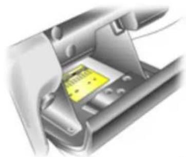 Interior view of a car showing a yellow plastic clip inside the hood (no text or symbols visible)