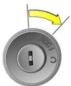 Close-up of a circular mechanical knob with a yellow arrow indicating rotation (no text or symbols)