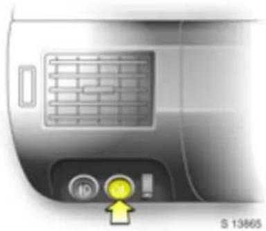 Close-up of a car air vent with control buttons and a yellow arrow pointing to the bottom-right corner (no text or symbols on main subject)