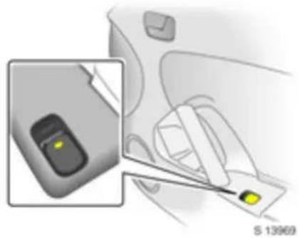 Illustration of a hand holding a small electronic device with a yellow indicator light, next to an inset image of a handheld device (no text or symbols visible)