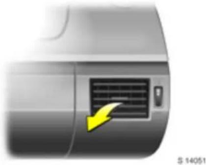 Close-up of a car's side panel with a yellow arrow pointing to the grille (no text or symbols visible)