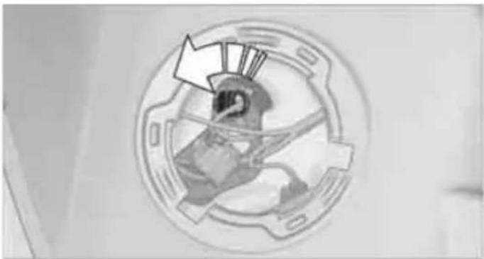 Cross-sectional view of a mechanical component with internal components and a directional arrow (no text or symbols)