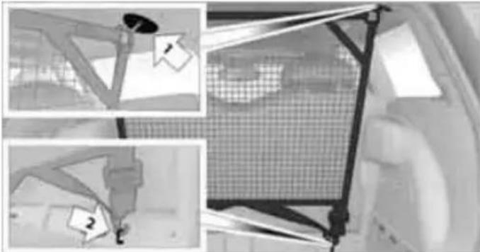 Interior view of a vehicle showing a mesh fence and mechanical components (no visible text or symbols)