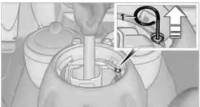Mechanical assembly diagram showing a hand turning a component with an inset detail of a pipe connection (no text or symbols)