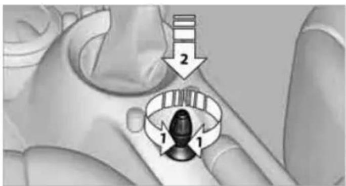 Medical diagram showing a hand holding a device with labeled parts and directional arrows indicating motion or positioning.