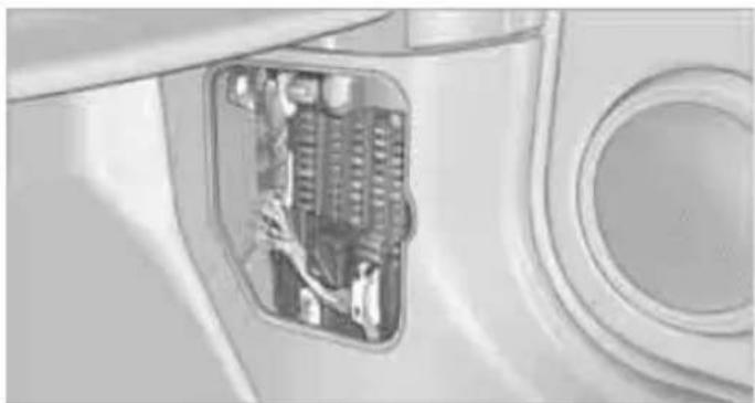 Interior view of a vehicle showing a mounted electrical panel with visible wiring and components (no text or symbols)