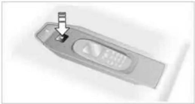 Close-up of a remote control device with a button and indicator lights (no visible text or symbols)