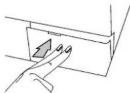 Hand pressing a button on a mechanical component (no text or symbols visible).