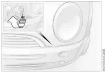 Illustration of a car's front bumper with a small inset showing a cooking pot (no text or symbols)
