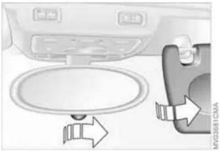 Interior view of a car showing the dashboard and seatbelt with directional arrows indicating movement (no text or symbols)
