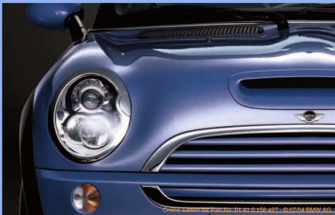 Close-up of a blue Mini Cooper car's head and grille, no visible text or symbols on the car body.