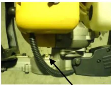 Close-up of a yellow industrial machine component with coiled tubing and mounting fixtures (no visible text or symbols)