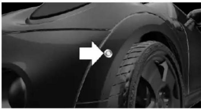 Close-up of a car tire with a white arrow pointing to the wheel rim (no text or symbols visible)