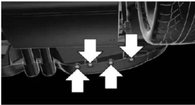 Close-up of a mechanical component with three white arrows pointing to specific features (no text or symbols visible)