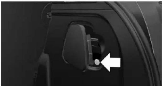 Close-up of a car door handle with a white arrow pointing to a button (no text or symbols visible)