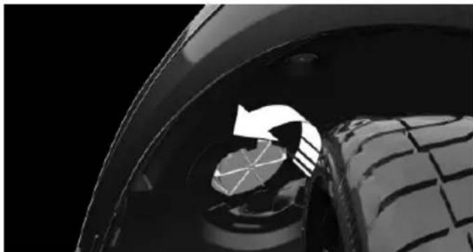 Close-up of a car tire wheel with a circular arrow indicating rotation or direction (no text or symbols)