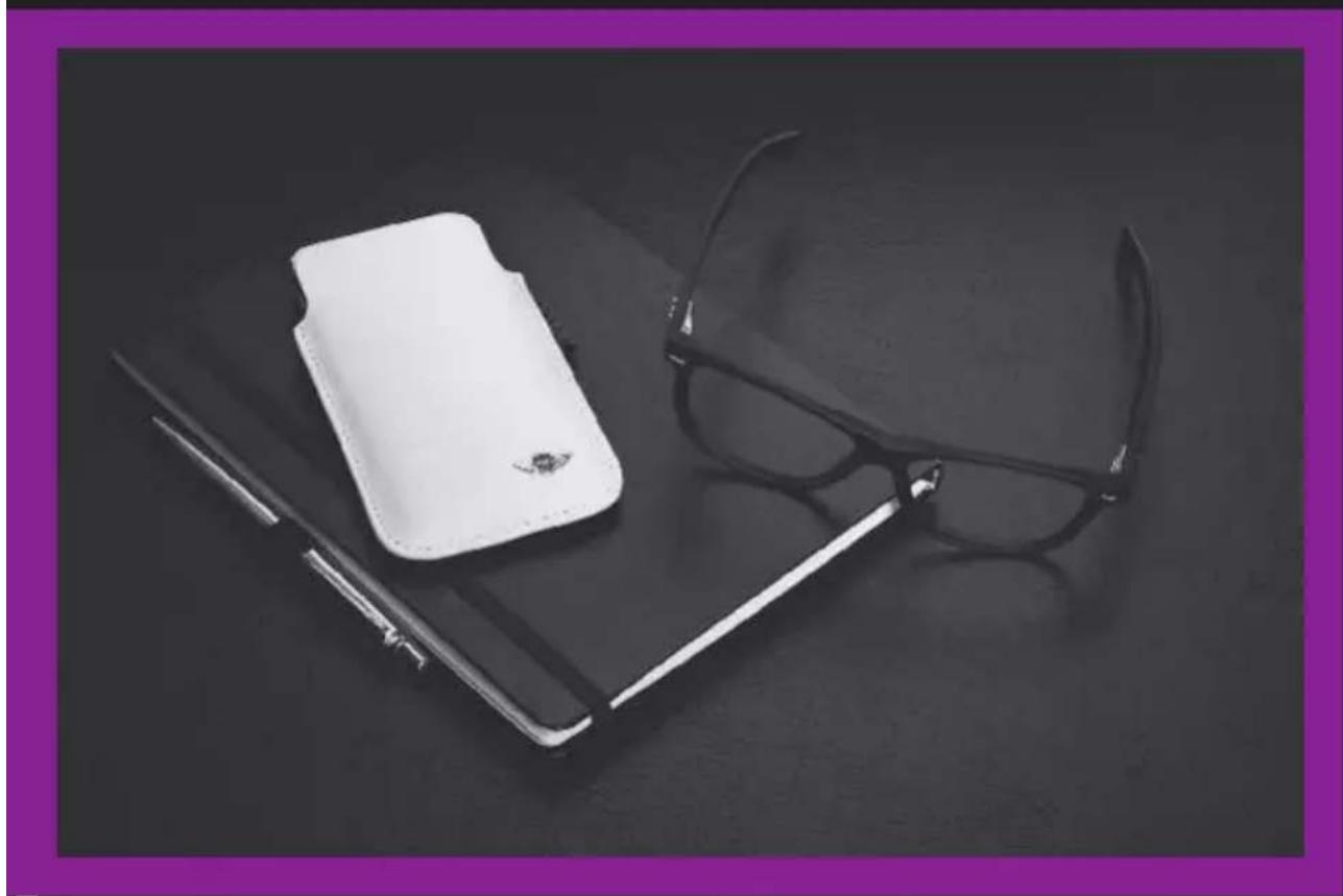 Black-and-white photo of a pair of eyeglasses and a wallet on a dark surface, framed by a purple border (no text or symbols visible)