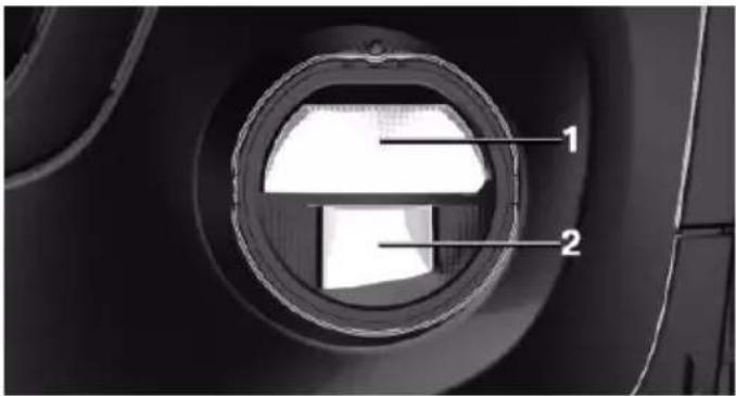 Close-up of a car wheel rim with labeled parts (1 and 2), showing internal structure without any text or symbols beyond labels.