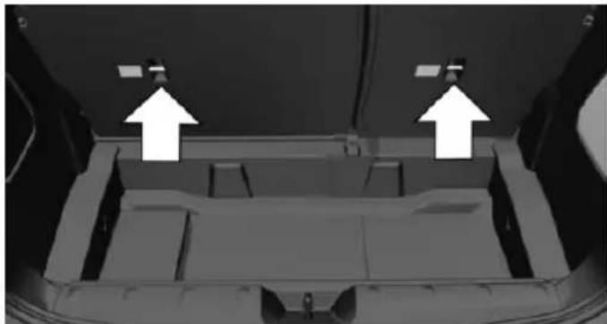 Interior view of a vehicle showing a vehicle chassis with two white arrows pointing to the top panel (no text or symbols visible)