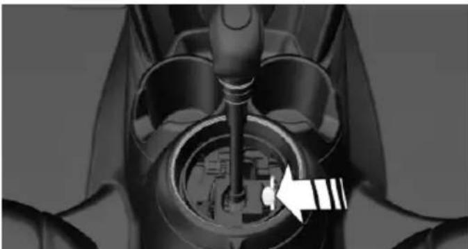 Close-up of a mechanical component with a white arrow pointing to a circular feature (no visible text or symbols)