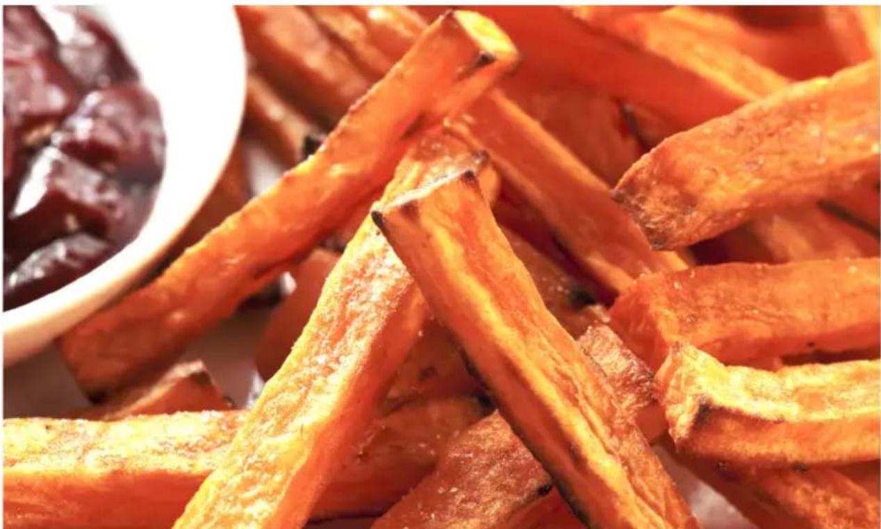 Close-up of golden-brown fried food strips with a white bowl in the background (no text or symbols visible)