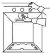 Line drawing of a hand using a tool to clean or install a device inside a container (no text or symbols)