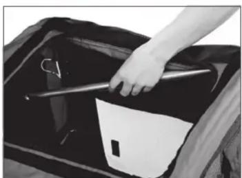 Close-up of a hand holding a tool over a car hood with visible paint and components (no text or symbols)