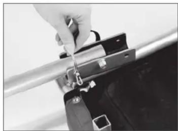 Close-up of a hand using a tool to adjust or install a metal clip (no visible text or symbols)