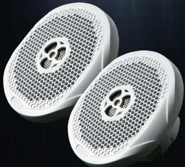 Two white plastic speaker covers with circular perforations and a central aperture, displayed against a dark grid background (no text or symbols visible)