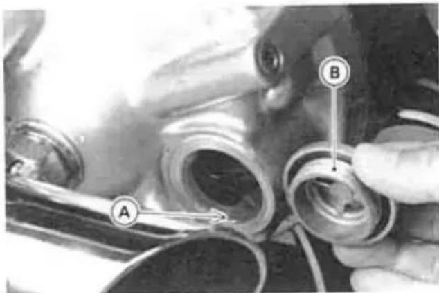 Close-up of mechanical components with labeled parts A and B, showing assembly or assembly steps