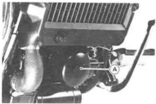 Close-up of a mechanical engine component with hoses and a labeled section (A), no visible text or symbols.