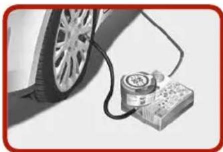 Close-up of a car tire connected to a pressure sensor and a battery (no visible text or symbols)