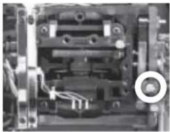 Close-up of a mechanical component with visible wiring and mounting holes (no text or symbols)
