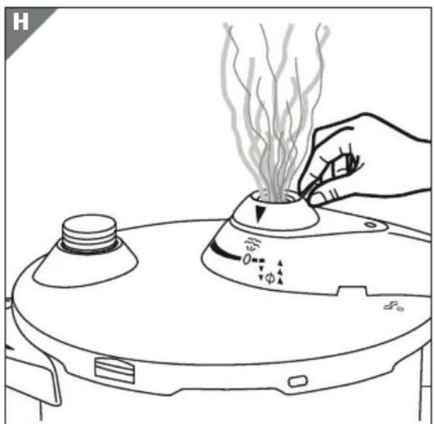 Line drawing of a hand pressing a small container with steam rising, next to a cylindrical device (no text or symbols)
