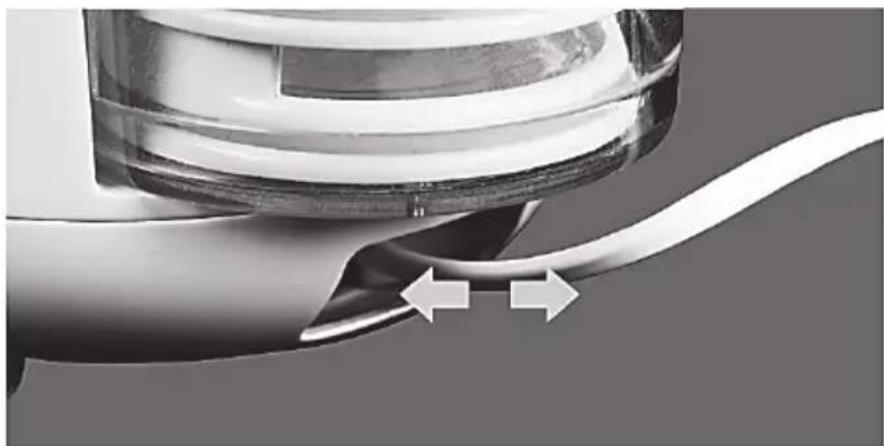 Close-up of a mechanical component with two directional arrows indicating movement or force (no text or symbols visible)