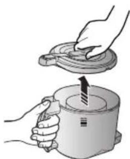 Illustration of hands using a tool to lift a cylindrical device (no text or symbols visible).