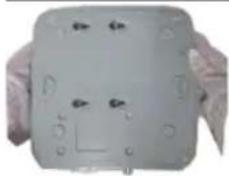 Close-up of a white rectangular electronic device with multiple circular components and mounting holes (no visible text or symbols)