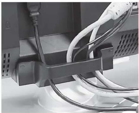Close-up of cable and socket connections between a computer monitor and a wall-mounted device (no visible text or symbols)
