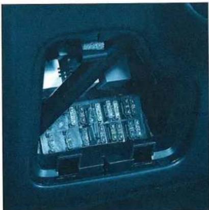 Interior view of a dark, illuminated mechanical or electronic component with no visible text or symbols