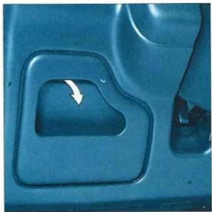 Close-up of a car interior showing a dark handle and a white arrow pointing to a small component (no text or symbols visible)