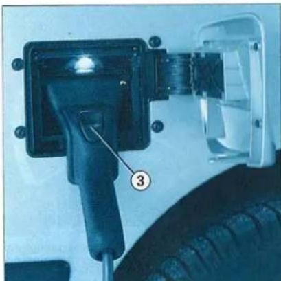 Close-up of a car charging plug with a numbered component (3) pointing to its socket, no visible text or symbols.