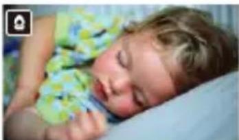 Close-up of a sleeping baby lying down, wearing a floral pattern (no visible text or symbols)