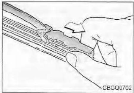 Illustration of a hand holding a tool interacting with a mechanical component (no text or symbols visible)