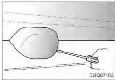 Simple line drawing of a hand holding a tool over a surface, with no text or symbols present.