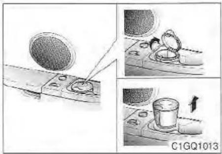 Three-panel illustration showing mechanical components: a circular component being inserted, a close-up of a tool on a surface, and a cylindrical container with an arrow indicating motion (no text or symbols)