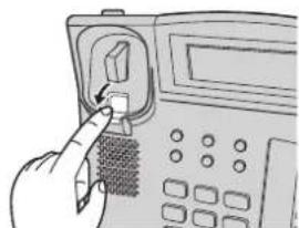 Hand inserting a button into a device, no text or symbols visible.