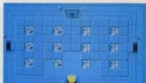 Top-down view of a blue rectangular space with grid-like patterns and small yellow markers at the bottom (no text or symbols visible)