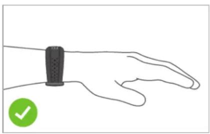 Line drawing of a human wrist with a circular green checkmark icon (no text or symbols on the hand)