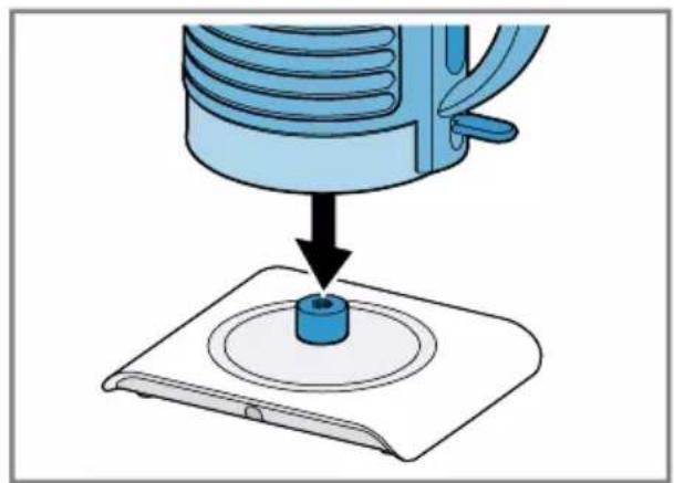 Illustration of a blue mechanical device pressing a circular component onto a base (no text or symbols)