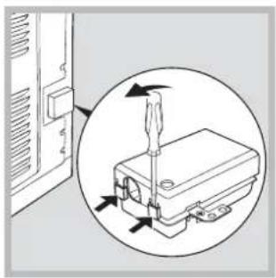 Diagram showing a screwdriver inserted into a device component, with arrows indicating direction (no text or symbols present).